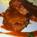 Foto de Carne mechada, puré de papas y tomates cherry asados.