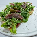 Foto de Pizza rúcula, jamón crudo y parmesano (entera)