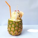 Foto de PIÑA CON HELADO. base de crema de la casa y queso casero rellena de trocitos de piña y una bola de helado