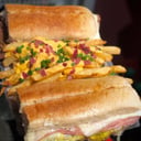 Foto de Sandwich de milanesa con adicional de cheddar, panceta y verdeo