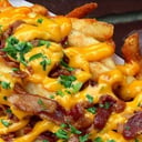 Foto de Papas fritas con queso y bacon