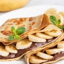 Foto de Crepe de banano con chocolate y crema chantilly