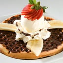 Foto de Waffle de fresas y banano con nutella, helado y chantilly