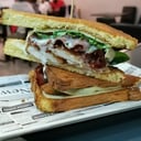 Foto de SÁNDWICH SUCRE ( POLLO MARINADO, BACON, QUESO EDAM, BROTES Y SALSA DE YOGUR.
