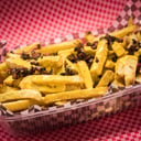Foto de Porcion de papas con cheddar y bacon