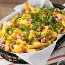 Foto de Papas DON FERRO (papas rutiscas, queso cheddar, panceta crocante y verdeo)