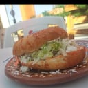 Foto de Pambazo sencillo (papa con longaniza, lechuga, crema y queso) 