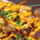 Foto de Papas + Cheddar Porción: Grande