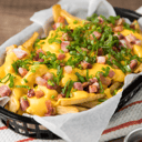 Foto de Papas con cheddar, bacon y verdeo