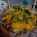 Foto de Porcion de papas fritas con cheddar 