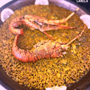 Foto de Paella de langosta y alcachofas.